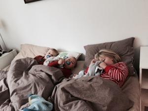 Kids snuggling in bed