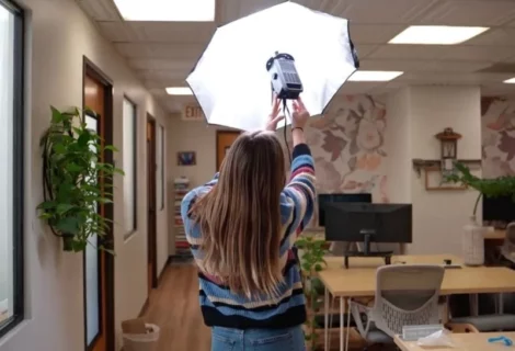 blond woman demonstrates booth setup